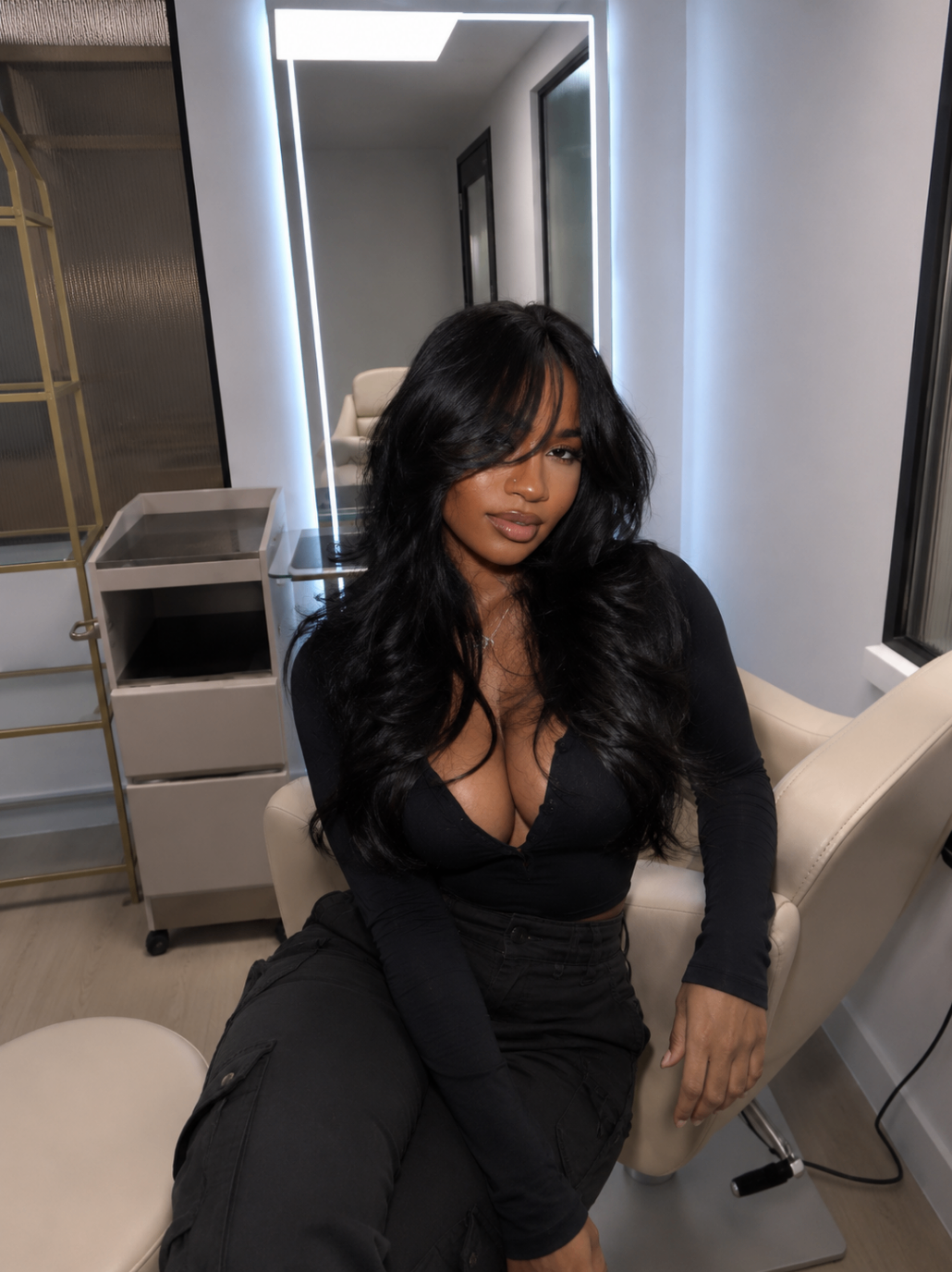 Seated salon portrait with glossy black waves