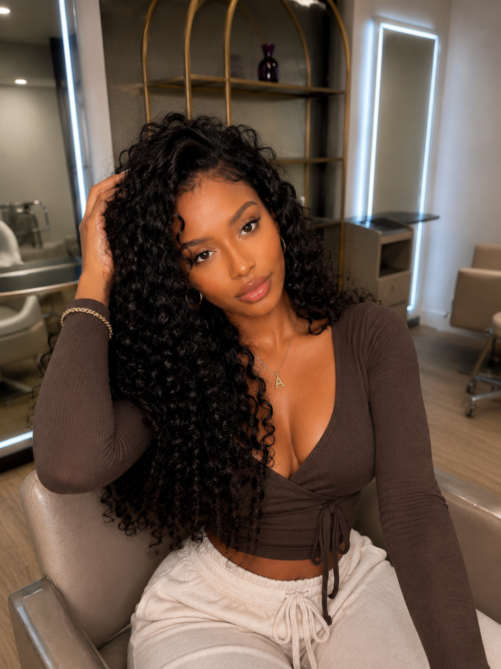 Client with deep curls seated in the salon