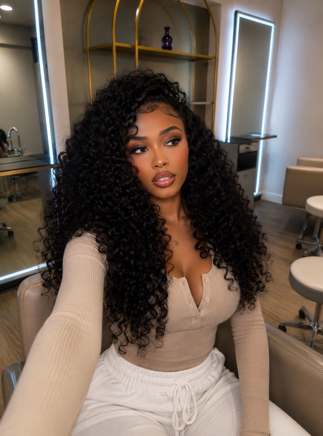 Client with voluminous curls seated in the studio