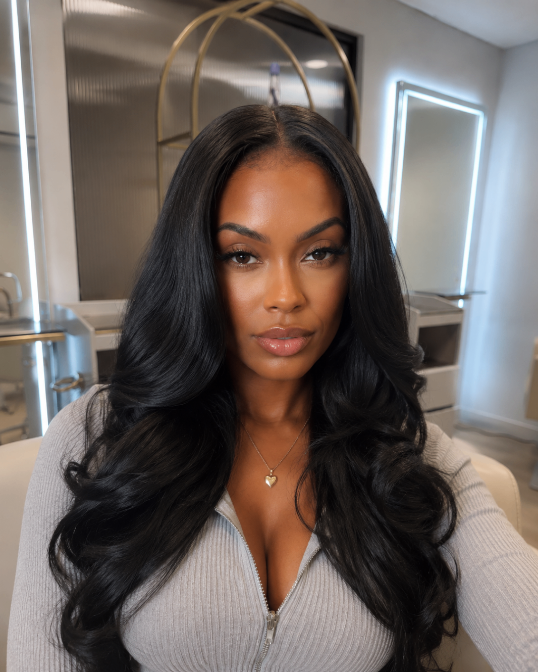 Sleek middle-part waves finished at the chair